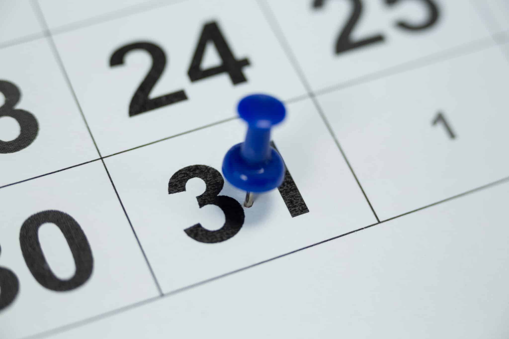 Close Up Of Blue Pin Push On Day 31st Of Month End On White Calendar